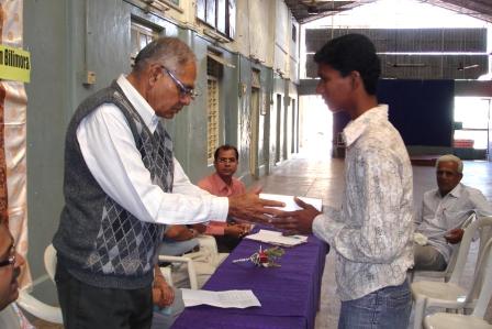 SPEF Education assistance cheque being presented by Dineshbhai Prajapati President of Bilimora Samaj