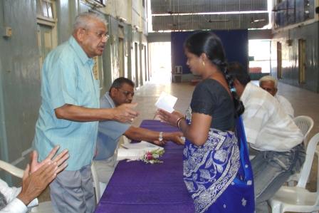 SPEF Education assistance cheque being presented to Mother of Student by Shree Gulabbhai